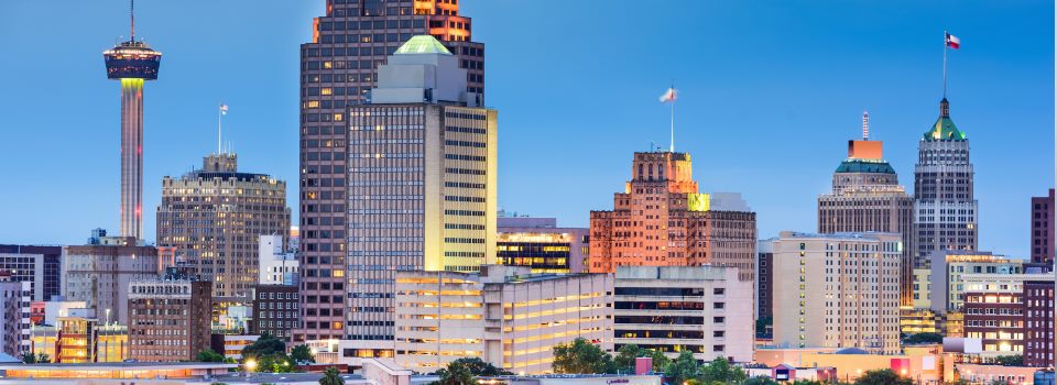 Couple sitting together on couch looking at laptop