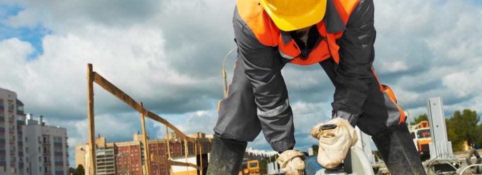 Couple sitting together on couch looking at laptop