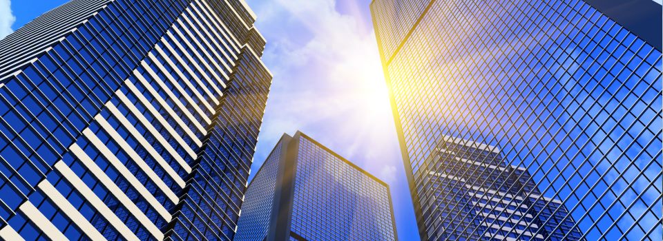 Couple sitting together on couch looking at laptop